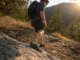 Barefoot Hiking Shoes Buying Guide for Real Trail Hiker in barefoot hiking shoes stepping down a rocky trail section
