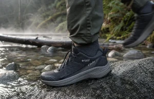 6 Men’s Waterproof Shoes Compared One Honest Pick Men's waterproof hiking shoe on wet granite beside a shallow trail creek at dawn
