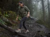 Best Women’s Waterproof Shoes (And When to Skip Them) Woman in waterproof hiking shoes stepping across a wet muddy trail on an overcast morning