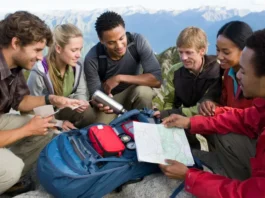 Hikers meticulously checking their gear, embodying the hiking checklist and the 10 essentials for a safe outdoor adventure.