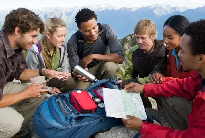 Hikers meticulously checking their gear, embodying the hiking checklist and the 10 essentials for a safe outdoor adventure.