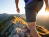 Men’s Hiking Shorts: What 100+ Miles of Testing Reveal A male hiker wearing durable hiking shorts navigates a rocky mountain trail during golden hour, demonstrating the performance revealed by extensive testing.