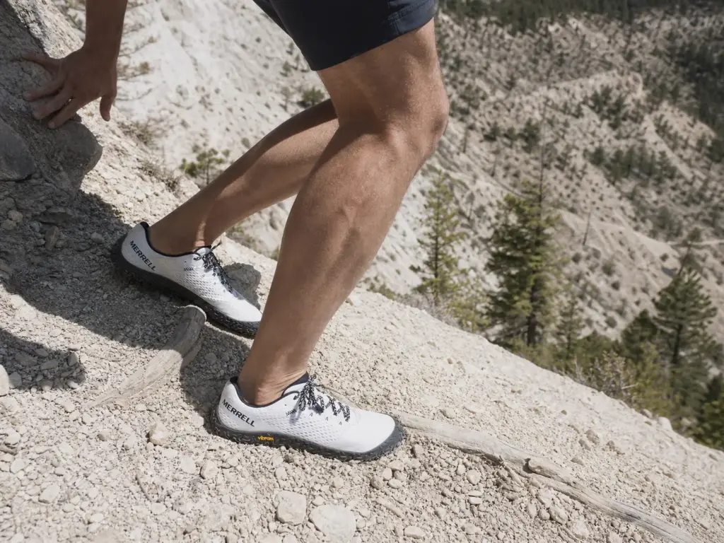 Hiker braking downhill in zero drop shoes with calf and ankle under load