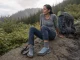 Best Backpacking Shoes That Won’t Bottom Out at Mile 10 Hiker resting at a switchback in backpacking shoes with a loaded pack beside her