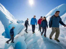 Diverse hikers with crampons walk on the textured blue ice of Perito Moreno Glacier, showcasing a guide to glacier walking tours.