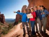 Sedona’s Best Hikes: A Trail Guide for Every Hiker Diverse hikers on a panoramic Sedona red rock overlook with trails visible below, symbolizing a comprehensive trail guide to Sedona's best hikes.