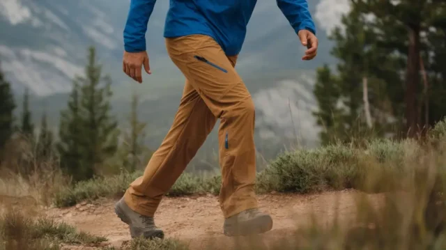 hiker in durable men’s hiking pants on a scenic trail, showcasing top picks and expert reviews.