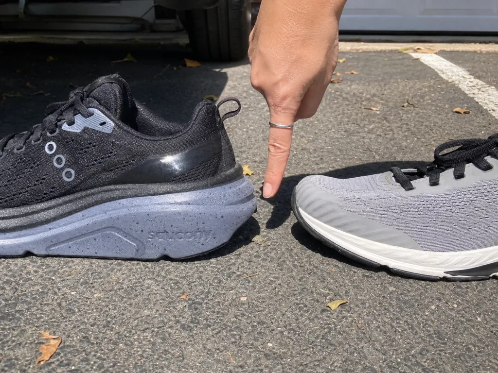 Two shoes side by side on pavement showing walking shoe and running shoe differences