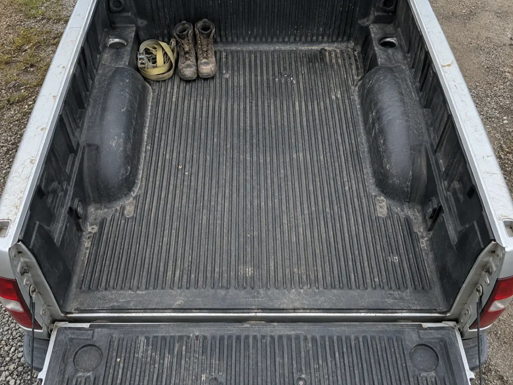 Empty pickup truck bed with tailgate down, the open cavity a bed tent needs to pitch in
