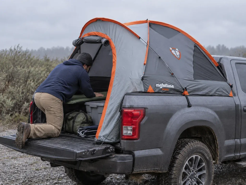 Floorless truck bed tent pitched over gear already loaded in the pickup bed