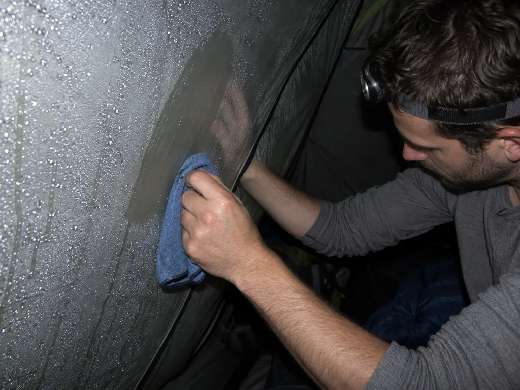 Condensation wiped off the inside of a backpacking tent wall with a pack towel before dawn
