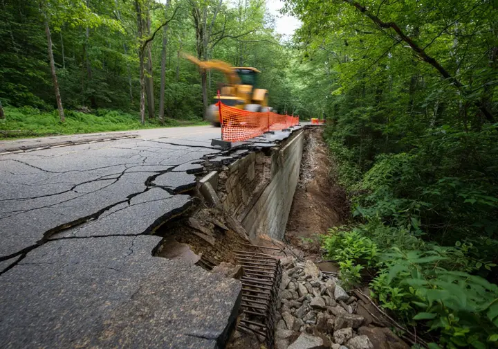 Deteriorated, cracked pavement and failing retaining wall on the old Laurel Falls Trail, explaining why the trail is closed for rehabilitation by park management.