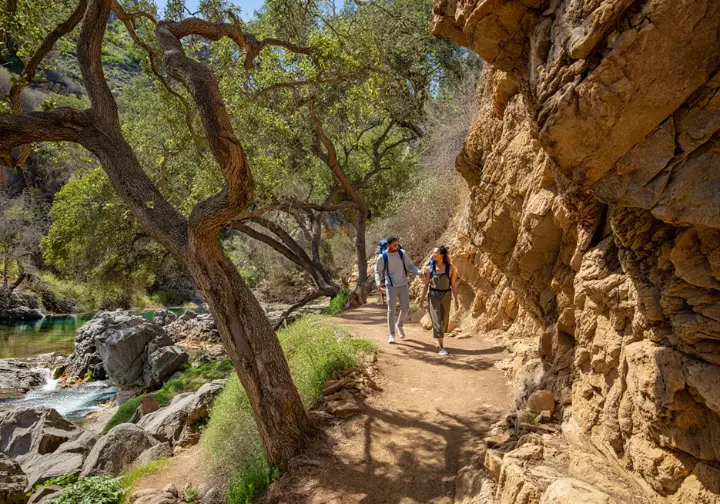 Santa Monica Mountain hikes: Hikers exploring the unique rock formations and landscape of Malibu Creek State Park.