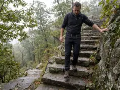 Bear Mountain Hike Difficulty Has Two Real Answers Hiker descending the stone steps on the Bear Mountain hike in New York on an overcast morning