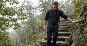 Bear Mountain Hike Difficulty Has Two Real Answers Hiker descending the stone steps on the Bear Mountain hike in New York on an overcast morning