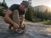 Why Low-Cut Hiking Shoes Beat Boots for Most Hikes Low-cut hiking shoes on a trail rock at dawn, laces being tightened before a hike