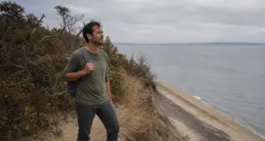 Places to Hike Long Island From Beach Dunes to Bluffs Hiker on the bluff trail above the beach at Sunken Meadow State Park, one of the best places to hike Long Island.