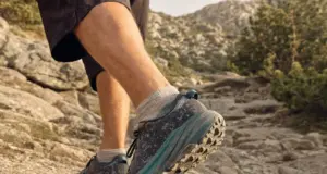 What Are Trail Running Shoes for Hiking, Really Close-up of a hiker's trail running shoes on a rocky mountain trail showing lugged outsole and mesh upper