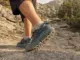 What Are Trail Running Shoes for Hiking, Really Close-up of a hiker's trail running shoes on a rocky mountain trail showing lugged outsole and mesh upper