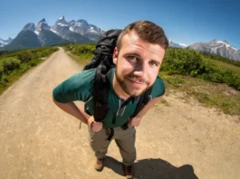 A confident hiker stands on a trail, highlighting hiking footwear, in a guide about what shoes to wear when hiking.