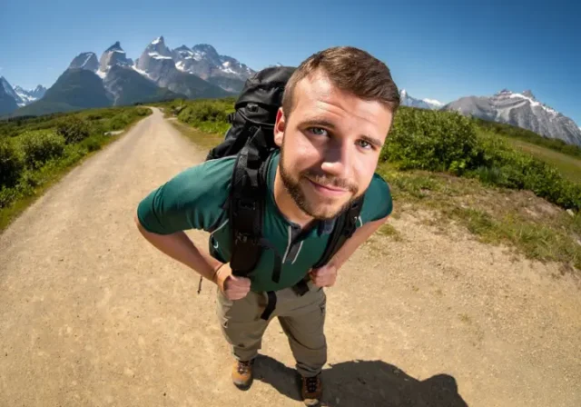 A confident hiker stands on a trail, highlighting hiking footwear, in a guide about what shoes to wear when hiking.