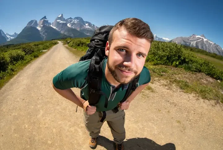 A confident hiker stands on a trail, highlighting hiking footwear, in a guide about what shoes to wear when hiking.