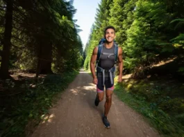 A hiker moves effortlessly on a forest trail, showcasing the benefits of a lightweight backpacking gear list for enhanced wilderness enjoyment.