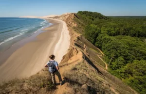 From Beaches to Bluffs: Long Island’s Best Hikes A panoramic view showcasing the diverse hiking landscapes of Long Island, blending sandy beaches with rugged, forested bluffs under clear skies, representing the best places to hike.