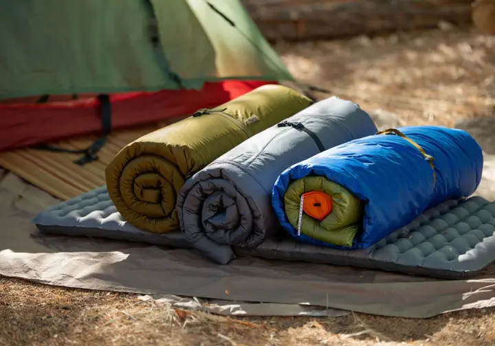 The "Big Four" lightweight backpacking gear items – backpack, tent, sleeping bag, and sleeping pad – displayed as the core components of a hiking pack.