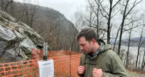 Breakneck Ridge Is Closed Until Mid-2027 Closed Breakneck Ridge trailhead fenced off below the Hudson Highlands ridgeline in New York