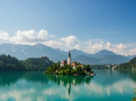 Panoramic view of Lake Bled with island church, castle, and Julian Alps.