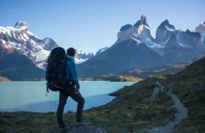 A Strategic Guide to the O Circuit in Patagonia A hiker looking out at the Torres del Paine massif, planning their route on the O Circuit in Patagonia at sunrise.