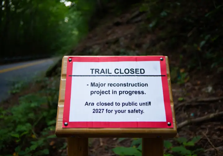 An official trail closed sign at the Breakneck Ridge trailhead, announcing the 2025-2027 closure for reconstruction.