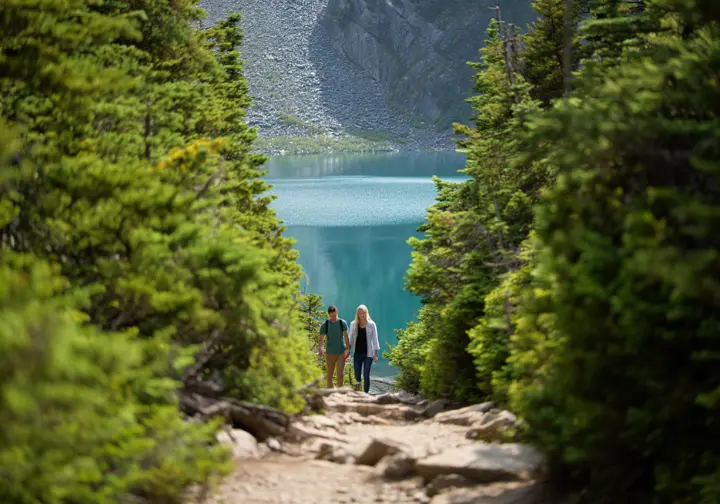 Hikers arriving at the beautiful turquoise water of Lindeman Lake, a popular hike in the Fraser Valley, BC.