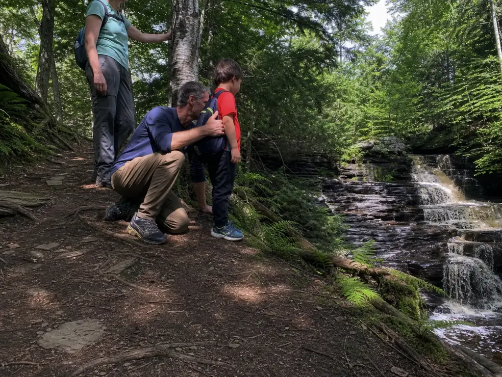 Family walking an easy trail to Shelving Rock Falls near Lake George, New York