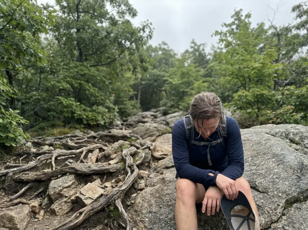 Hiker resting partway up the steep lower section of the Major Welch Trail at Bear Mountain