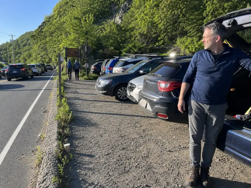 Full trailhead parking lot on Route 9D early on a weekend near Cold Spring, New York
