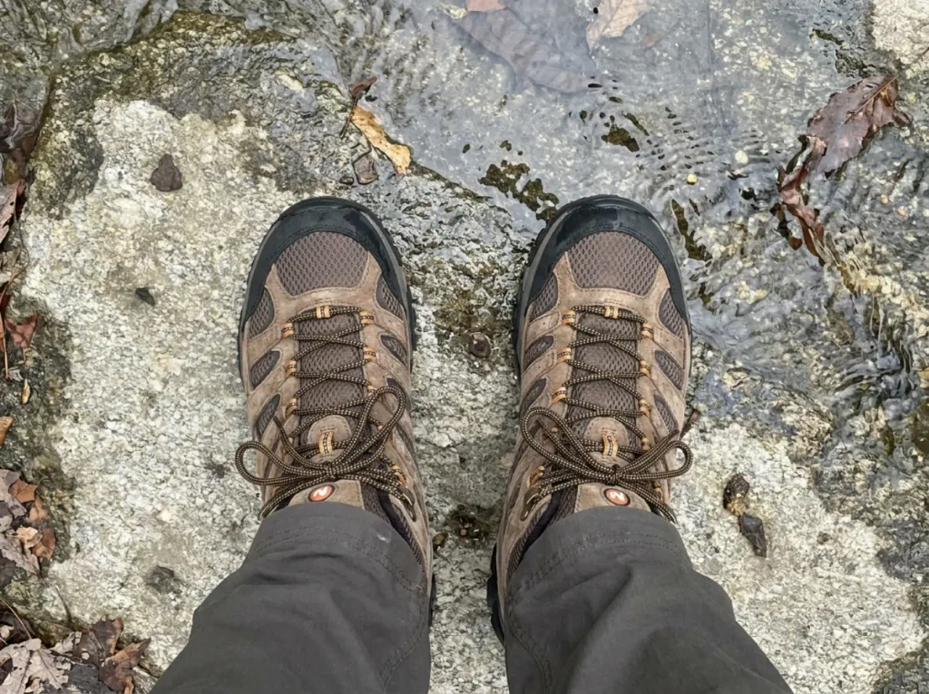 Merrell Moab 3 Mid waterproof boots on wet rock beside a shallow stream on the Verkeerder Kill Falls Trail