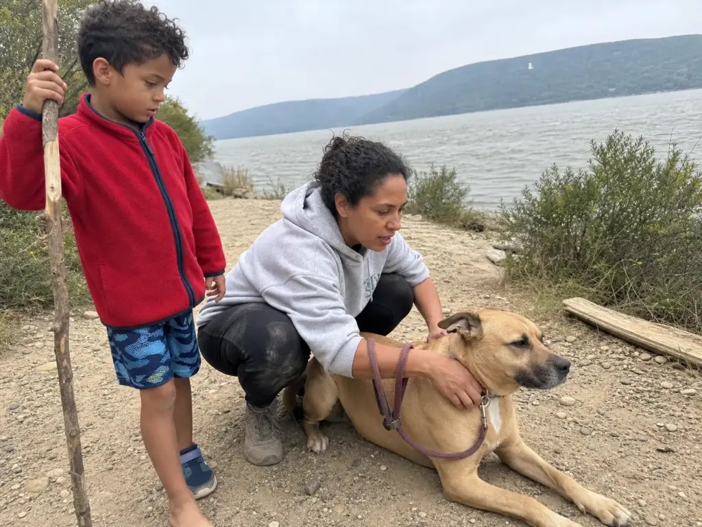 Family with a leashed dog on the flat Little Stony Point trail near Cold Spring, New York