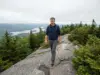 Bald Mountain Hiking Trails Aren’t All One Mountain Hiker on the open bedrock spine of the Bald Mountain hiking trails near Old Forge, New York