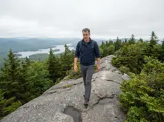 Bald Mountain Hiking Trails Aren’t All One Mountain Hiker on the open bedrock spine of the Bald Mountain hiking trails near Old Forge, New York