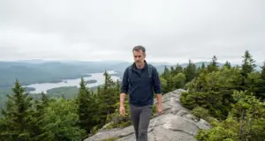 Bald Mountain Hiking Trails Aren’t All One Mountain Hiker on the open bedrock spine of the Bald Mountain hiking trails near Old Forge, New York