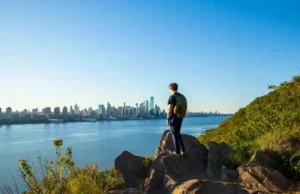 Best Hikes in North Jersey? NYC Skyline Views! Hiker enjoying panoramic New York City skyline views from a top hiking trail viewpoint in North Jersey.