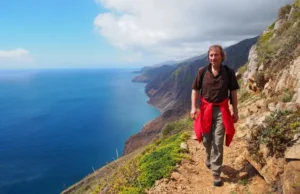 Escape Winter: Best Hiking in Europe in March Hiker enjoying an early spring coastal path in Southern Europe, representing the best hiking in Europe in March to escape winter.
