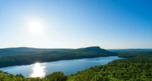 Fahnestock State Park NY: Your Year-Round Escape! Panoramic view of Fahnestock State Park NY showing Canopus Lake and forested hills, representing a year-round escape.
