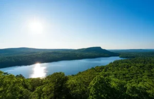 Fahnestock State Park NY: Your Year-Round Escape! Panoramic view of Fahnestock State Park NY showing Canopus Lake and forested hills, representing a year-round escape.