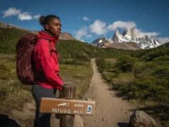 Patagonia South America Hiking: Tour vs Independent? Hiker at a trail junction in Patagonia contemplating the choice between a guided tour route versus hiking independently.