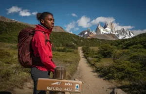 Patagonia South America Hiking: Tour vs Independent? Hiker at a trail junction in Patagonia contemplating the choice between a guided tour route versus hiking independently.