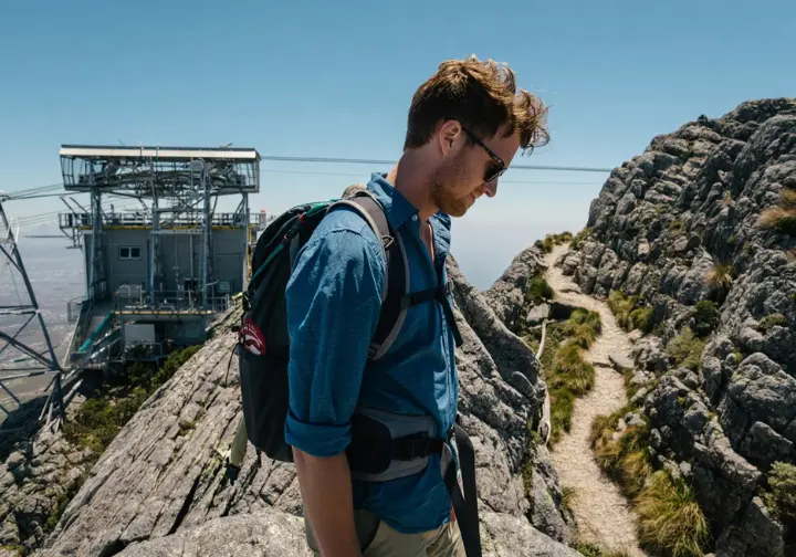 A view from a hiking trail on Table Mountain showing the complex choice between the aerial cableway and another winding path.