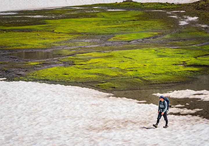 Swiss hiking trail in May showing variable conditions: sunshine, mud patches, and lingering snow, illustrating understanding May weather.